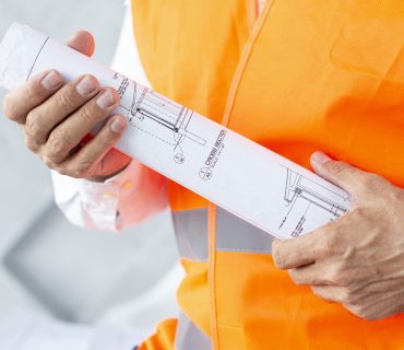 architect-holding-plans-close-up